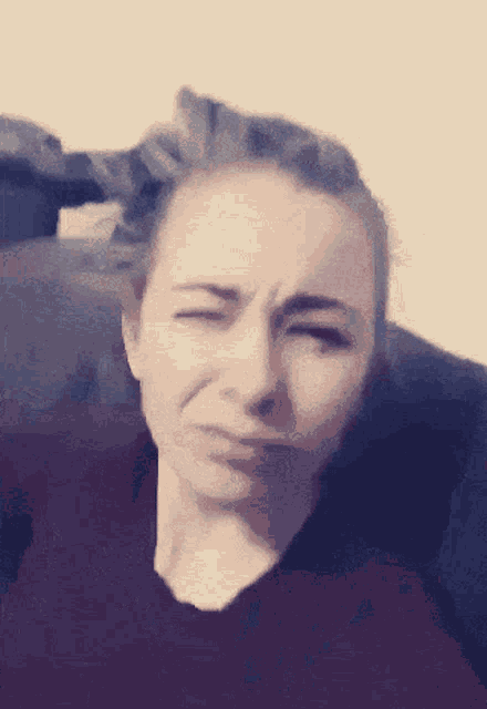 a close up of a woman 's face with her eyes closed