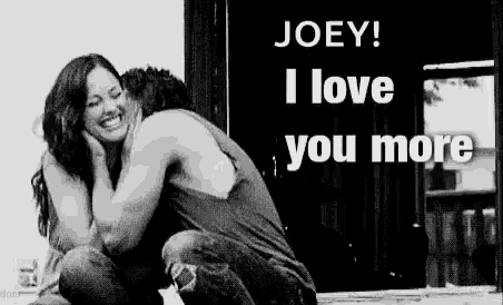 a black and white photo of a man and woman hugging .