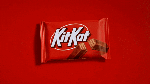 a kit kat bar is sitting on a red surface