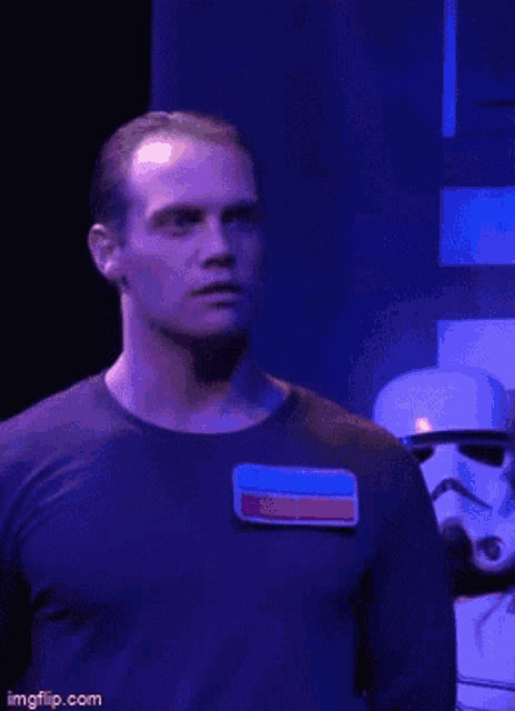 a man in a storm trooper costume is standing in front of a stormtrooper