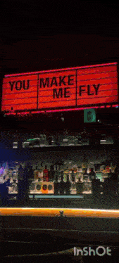 a sign that says you make me fly above a bar