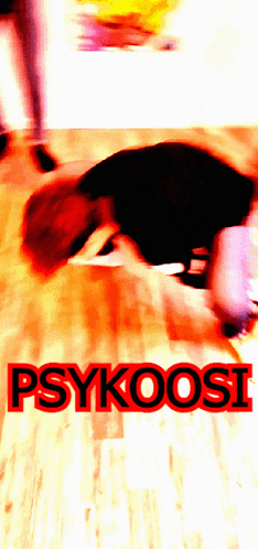 a blurred image of a person laying on the floor with the words psykoosi written in red