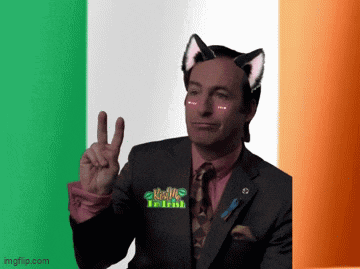 a man in a suit and tie with cat ears on his head giving a peace sign