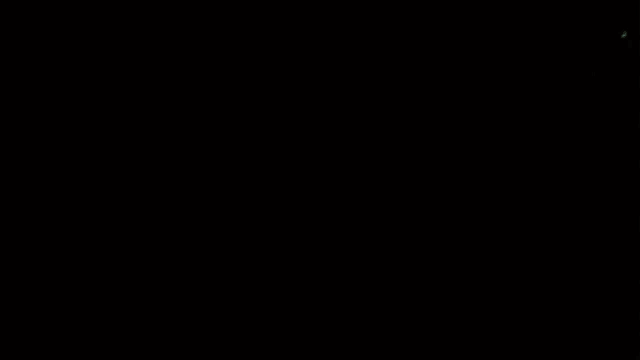 a silhouette of a person walking in the dark with a cloudy sky in the background
