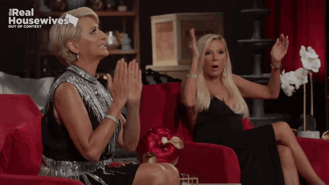 two women sitting on a red couch with the words real housewives out of context above them