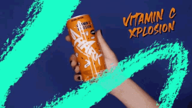 a hand holding a can of vitamin c explosion