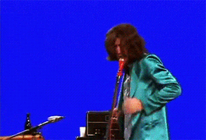 a man in a floral shirt is standing in front of an amplifier that says watt