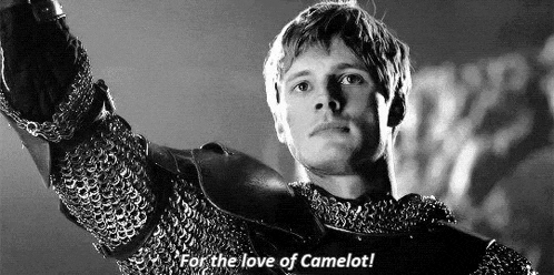 a black and white photo of a man in chain mail holding a sword and saying `` for the love of camelot ! ''