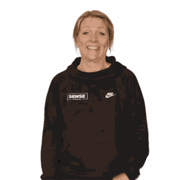 a woman wearing a black nike sweatshirt with the word sense on the front