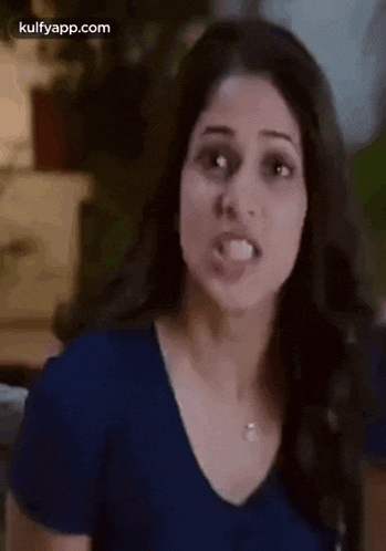 a close up of a woman making a funny face .