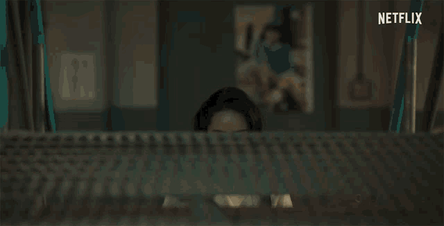 a woman is standing in a dark room with netflix written on the bottom