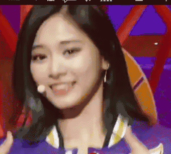 a close up of a woman 's face with a microphone in her mouth