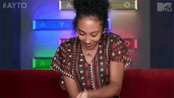 a woman sitting on a red couch with the name bria written on the bottom