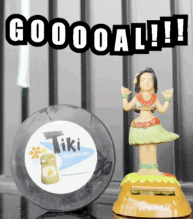 a hula dancer figurine sits next to a tire that says tiki on it