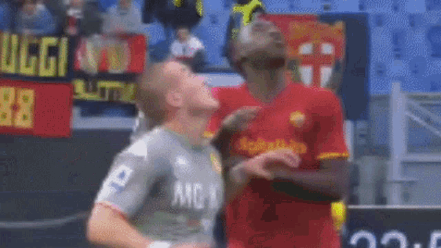 two soccer players are standing next to each other on a field