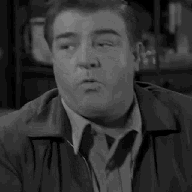 a black and white photo of an older man with his eyes closed .