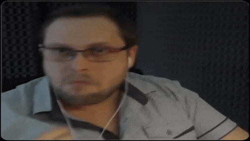 a man with glasses and a beard is wearing headphones