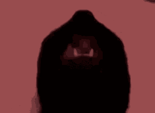a silhouette of a lion 's head with its mouth open