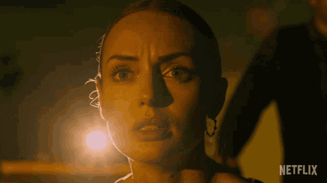 a close up of a woman 's face with netflix written on the bottom