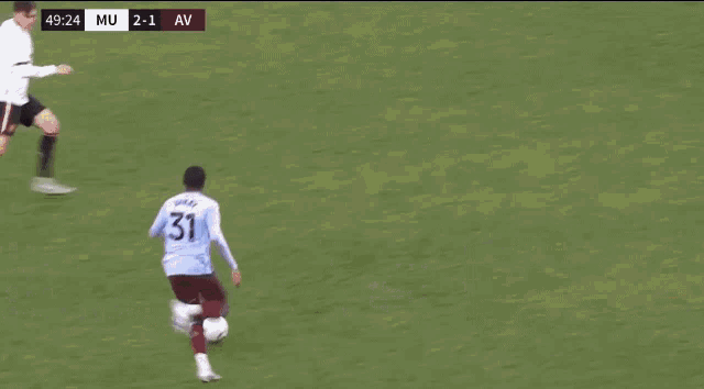 a soccer player kicks the ball in front of a banner that says dx technology