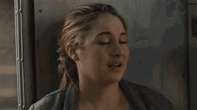 a close up of a woman 's face with her mouth open