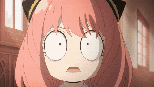 a close up of a girl 's face with a surprised look on her face