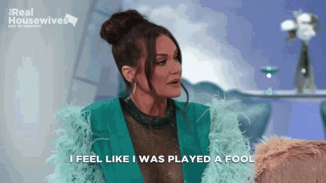 a woman in a teal feathered jacket says i feel like i was played a fool