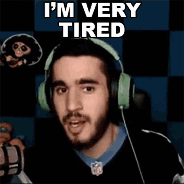 a man wearing headphones is saying i 'm very tired .
