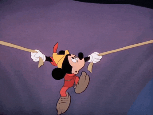 a cartoon of mickey mouse hanging upside down with a hat on his head