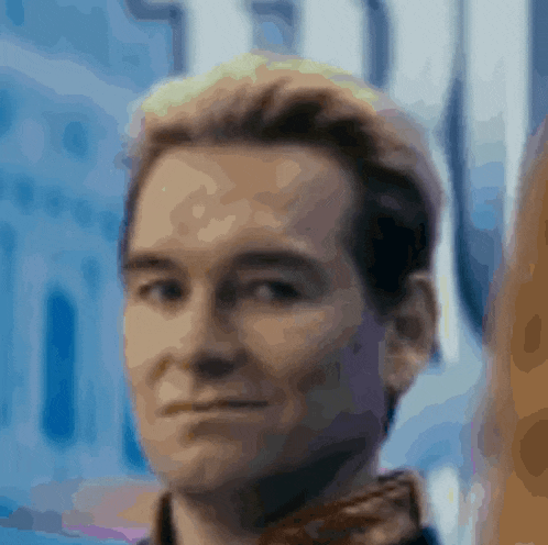 a close up of a man 's face with a blue background and a blurred background .