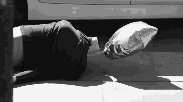 a person laying on the ground with a balloon in front of their head