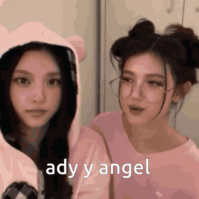 a couple of girls are standing next to each other and one of them is wearing a hoodie that says ady y angel