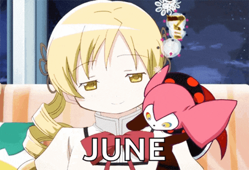 a girl holding a stuffed animal with the word june written on it