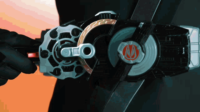 a person is holding a toy that has the letter m on the top