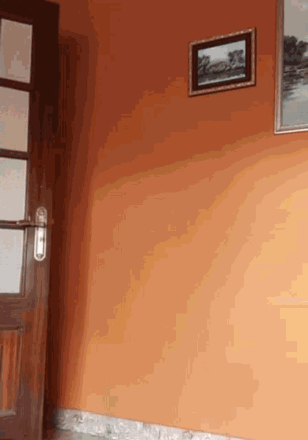 a painting hangs on a wall above a door