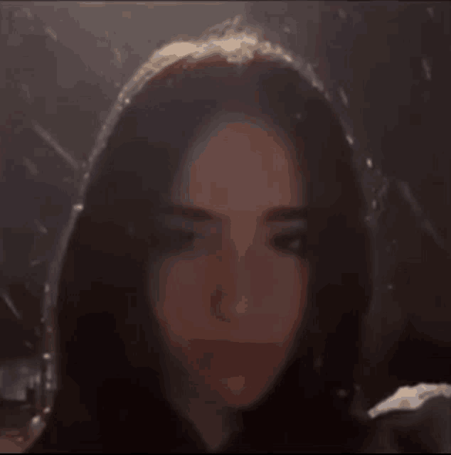 a close up of a girl 's face with a blurred background .