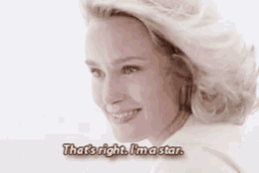 a woman with blonde hair is smiling and says that 's right i 'm a star