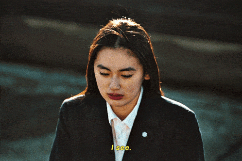 a woman in a suit says " i see " in yellow letters