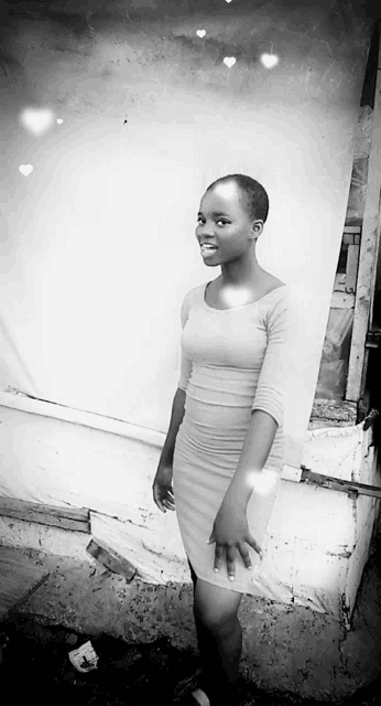 a black and white photo of a young woman in a white dress