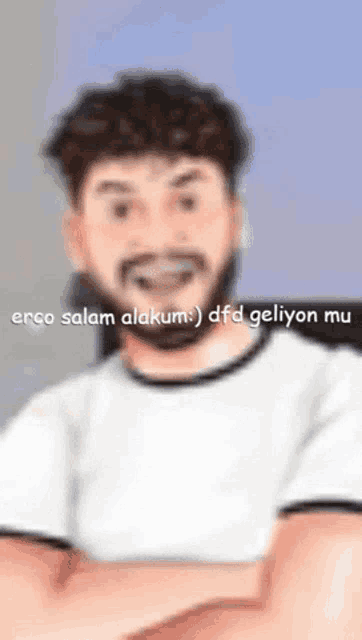 a blurry picture of a man with a beard and the words " erco salam alakum " on the bottom