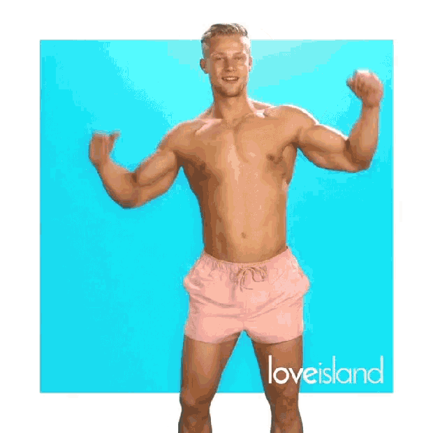 a shirtless man in pink shorts is flexing his muscles in front of a blue background .