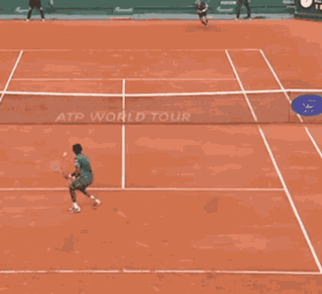 two tennis players are playing on a court sponsored by atp