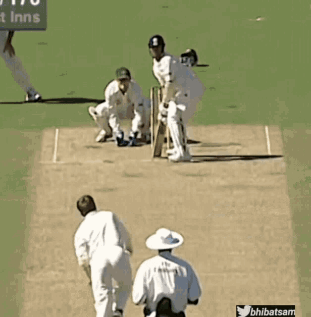 a cricket game is being played in front of a sign that says ' nt inns '