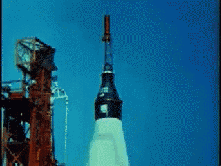 a rocket is being launched with a blue sky behind it