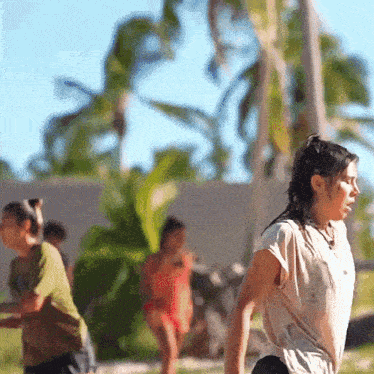 a woman in a white shirt is standing in a field