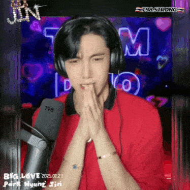 a man wearing headphones and a red shirt with the words big love written on the bottom