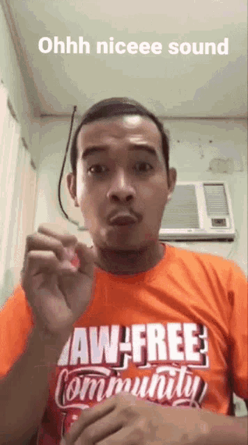 a man is wearing an orange shirt that says law-free community
