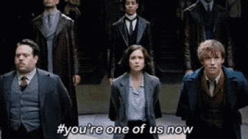 a group of people are standing next to each other and one of them says " you 're one of us now "
