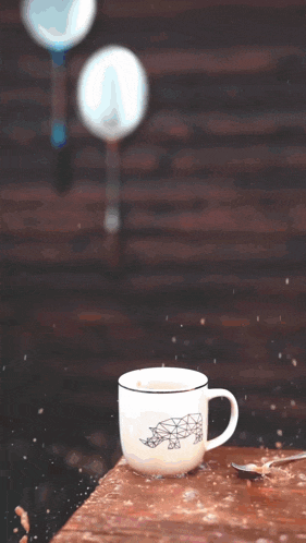 a cup of coffee sits on a wooden table with the word psalms written in red