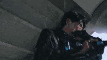 a blurry picture of a man holding a black object in his hand